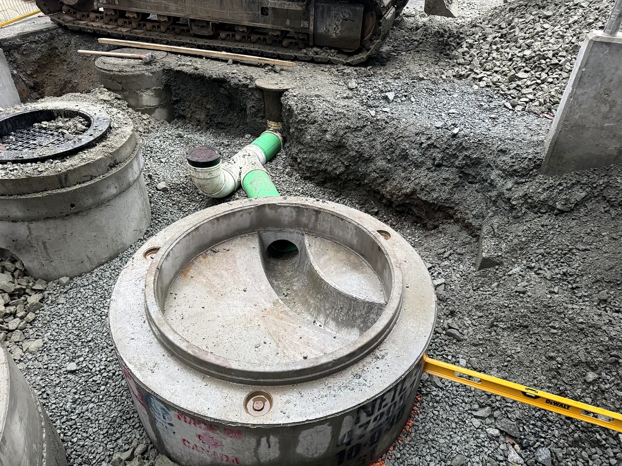 Precast manholes and PVC service connections set on granular bedding