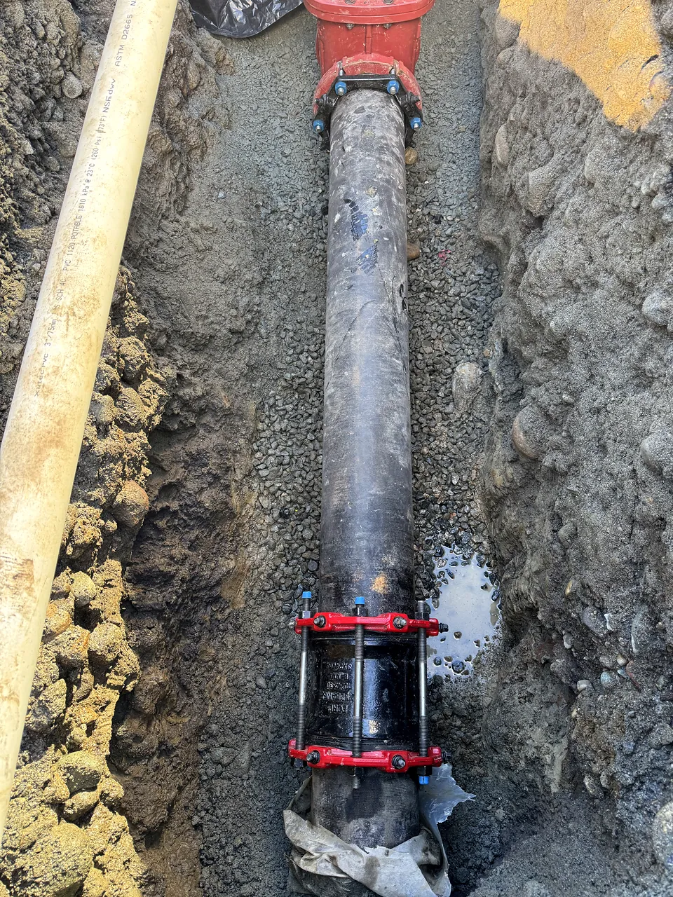 Ductile iron water main with restrained joints in the trench