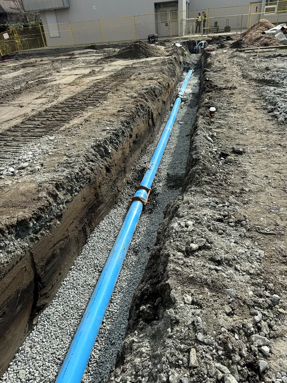 New PVC water main laid on bedding in the trench