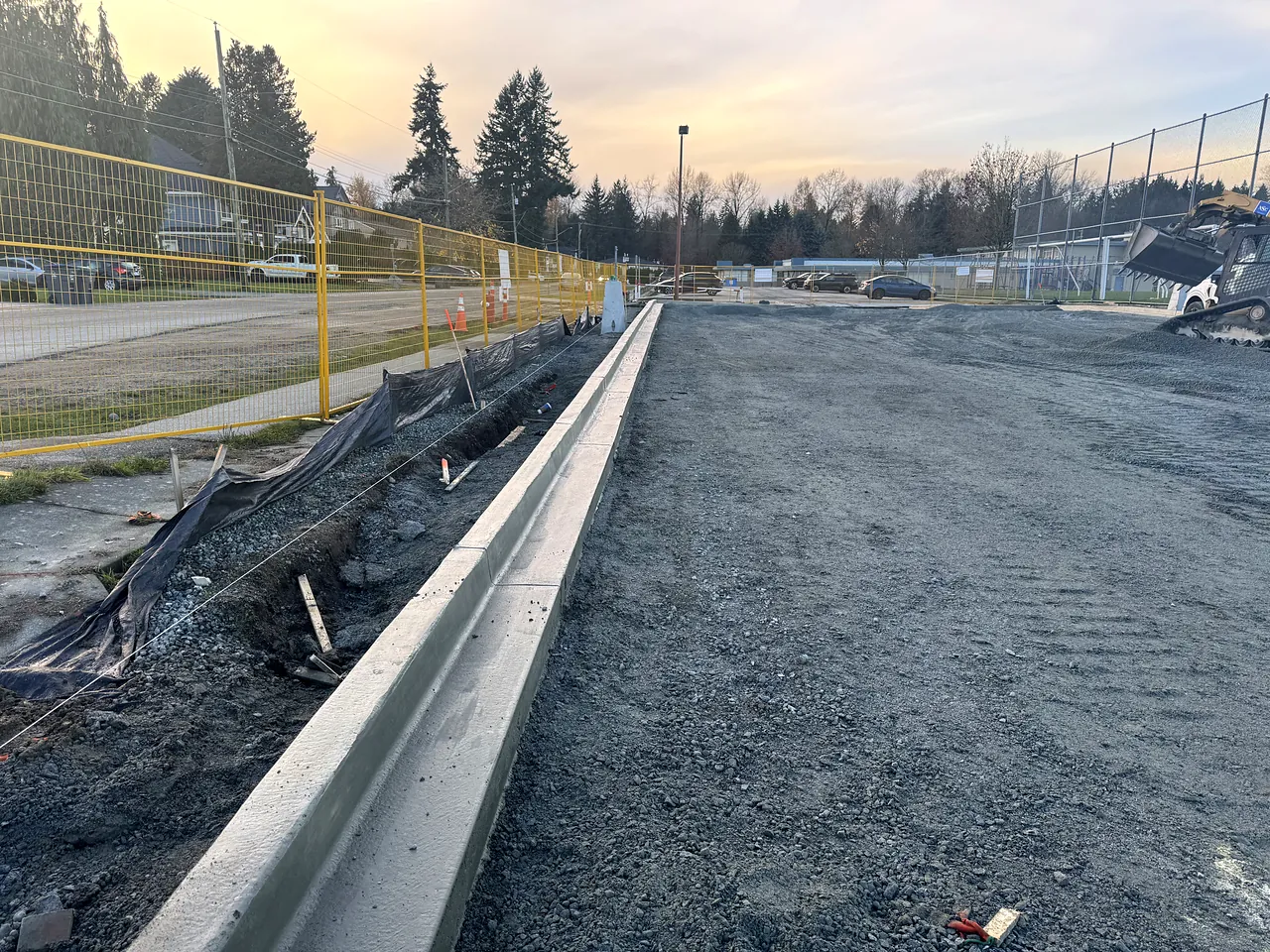 New concrete curb and gutter along the school field at Guildford Park