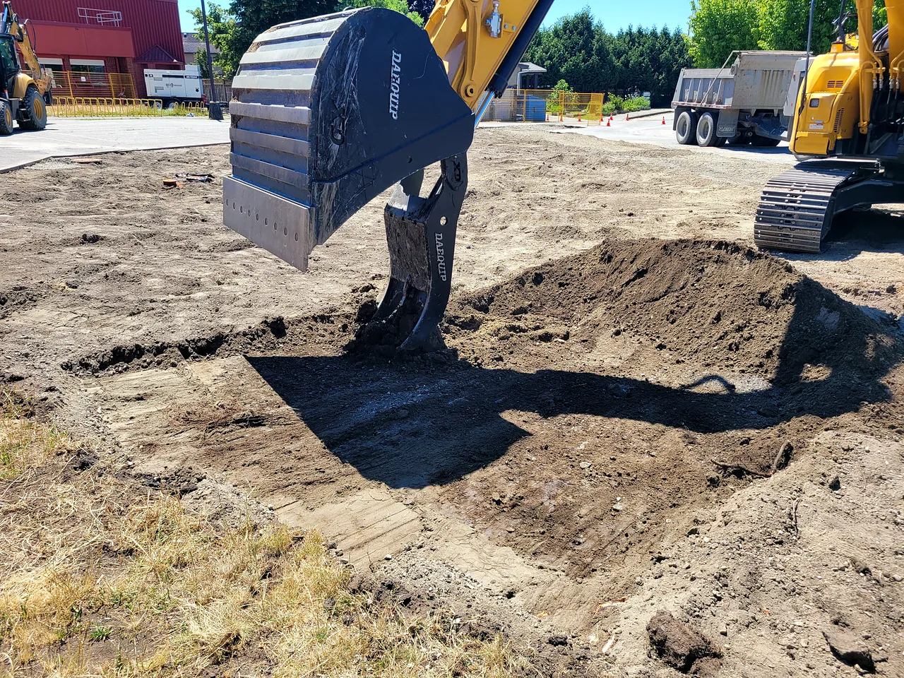 Excavator digging out the area during the seismic upgrade site work