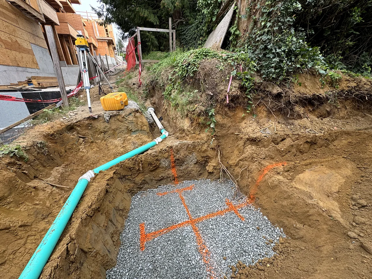 Storm pipe and gravel pad in an open excavation
