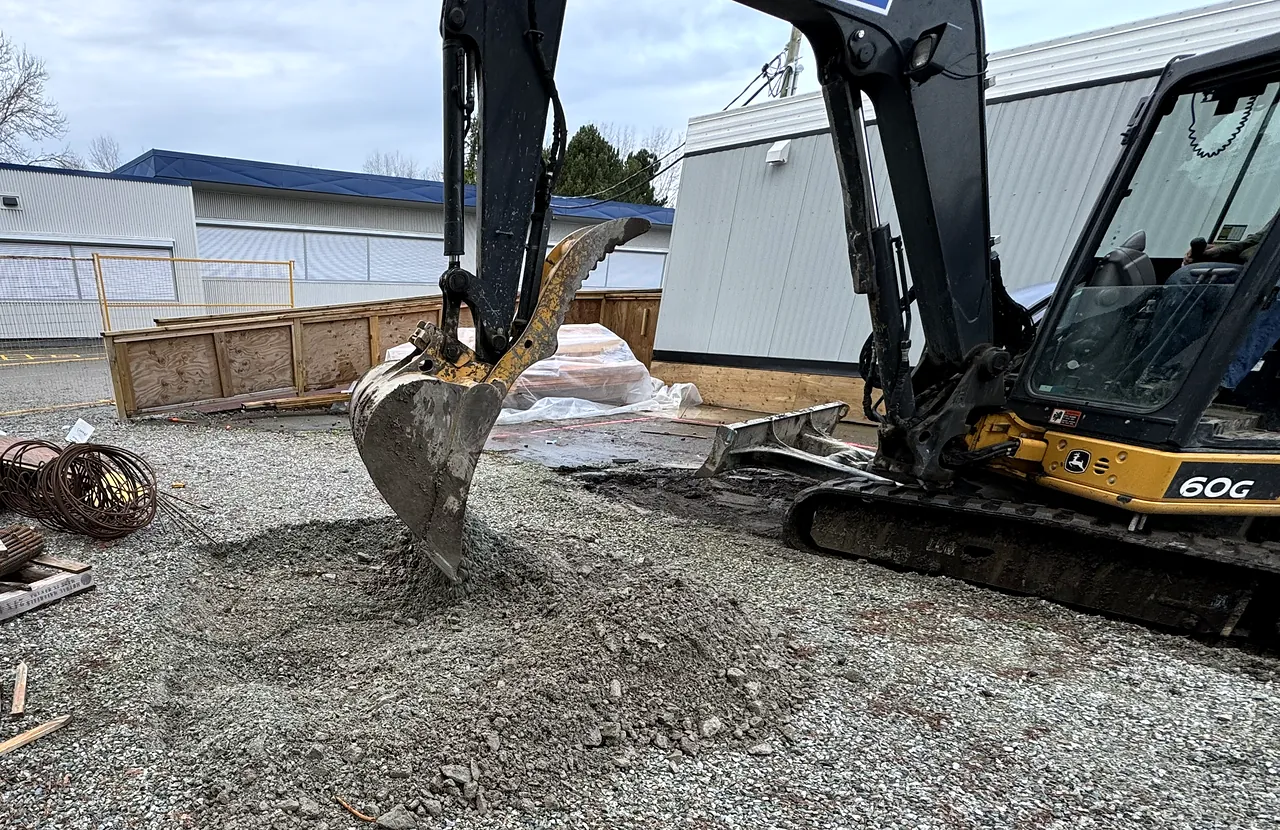 Excavator placing granular fill for the portable site at James Whiteside Elementary