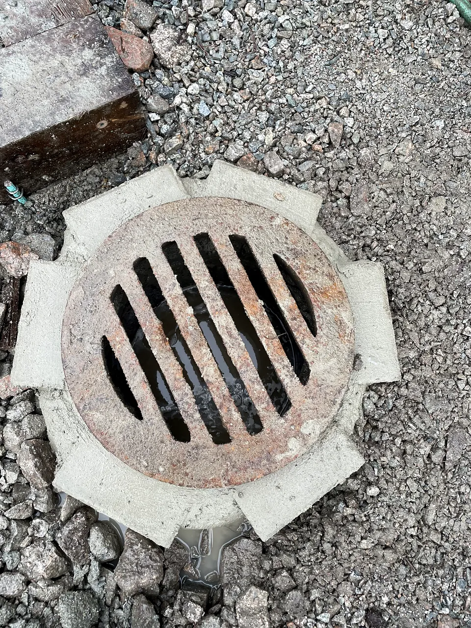 New catch basin frame and grate set in granular base at James Whiteside Elementary