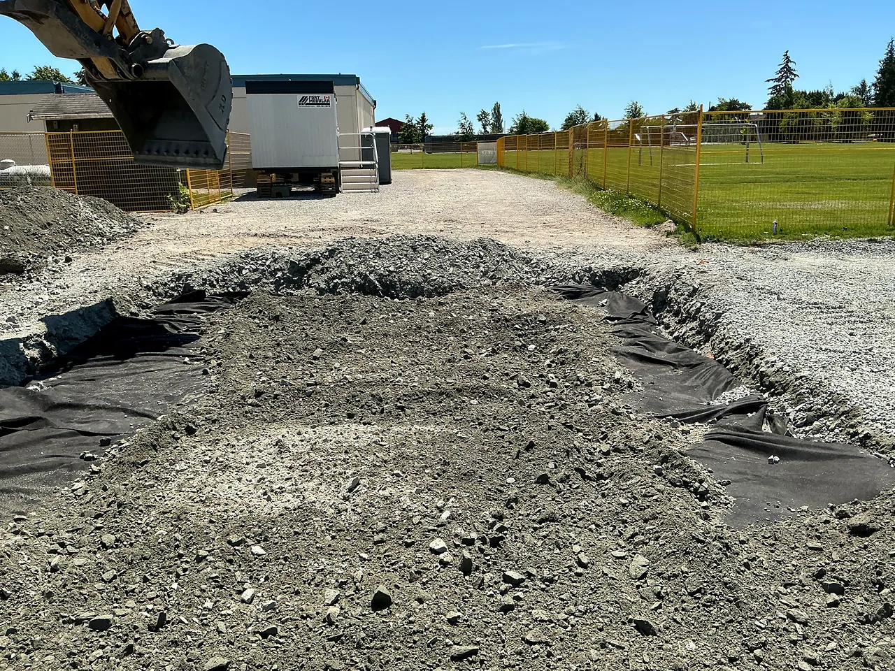 Excavated modular pad with geotextile and granular base