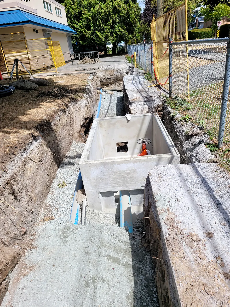 Precast valve chamber set in the service trench at McKinney Elementary