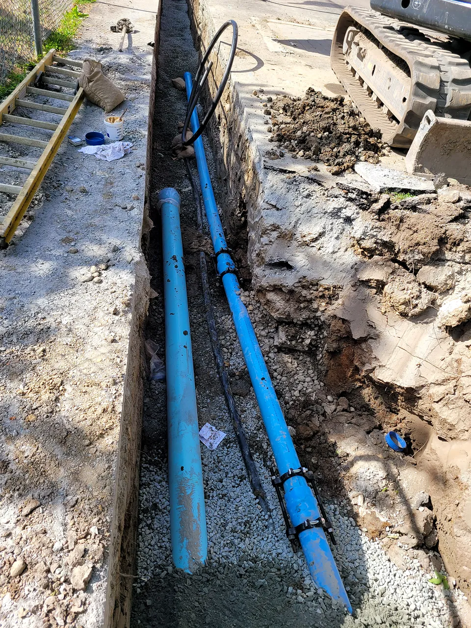 Parallel water service lines in an open trench at McKinney Elementary