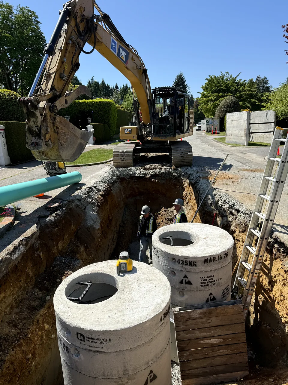 CAT excavator over two new precast manholes on Kingston Road