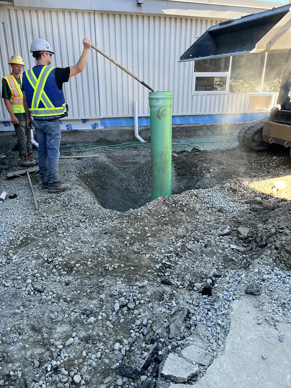 NSC crew setting a storm riser beside the school