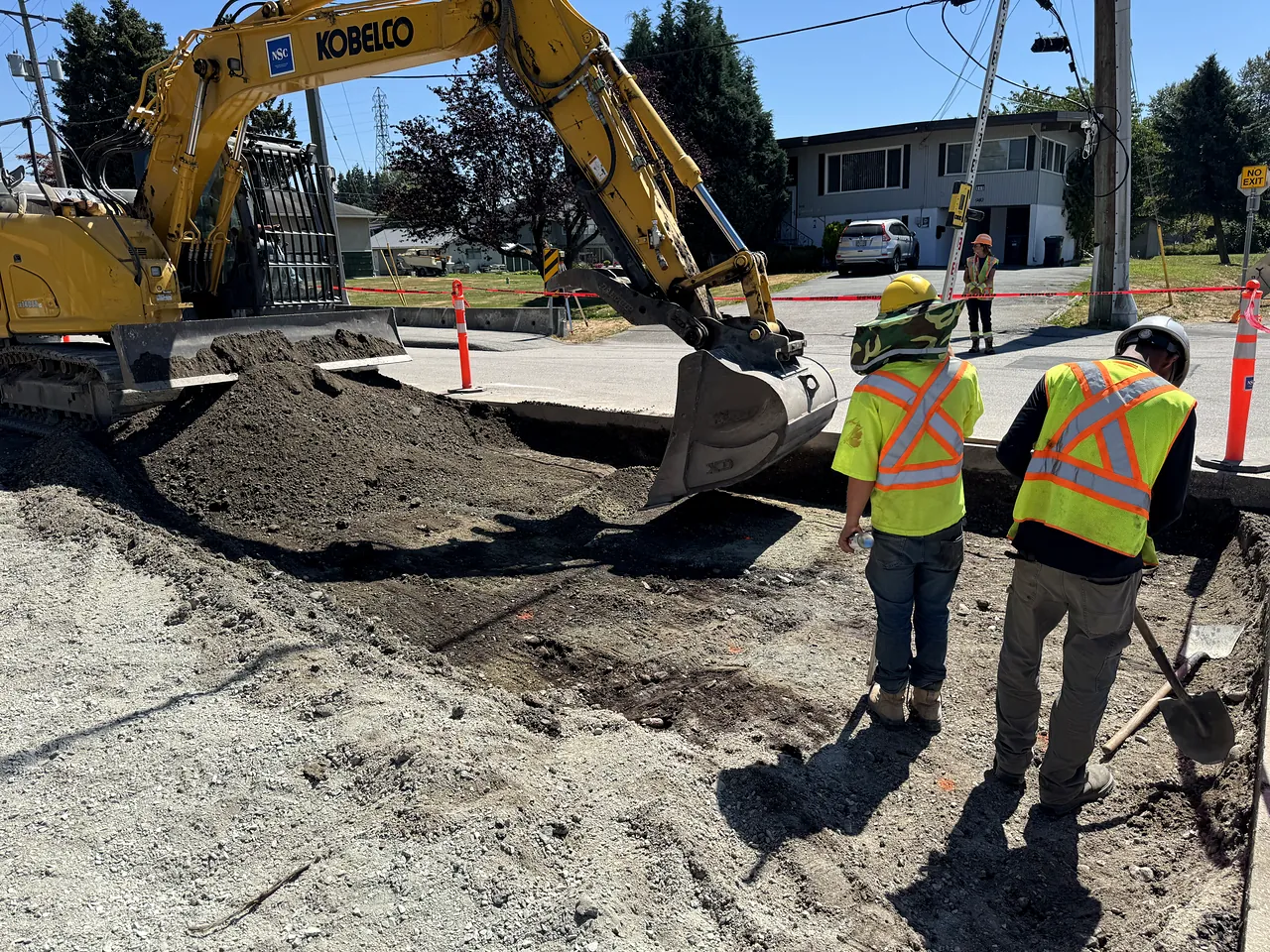 NSC crew and Kobelco excavator on road works in New Westminster