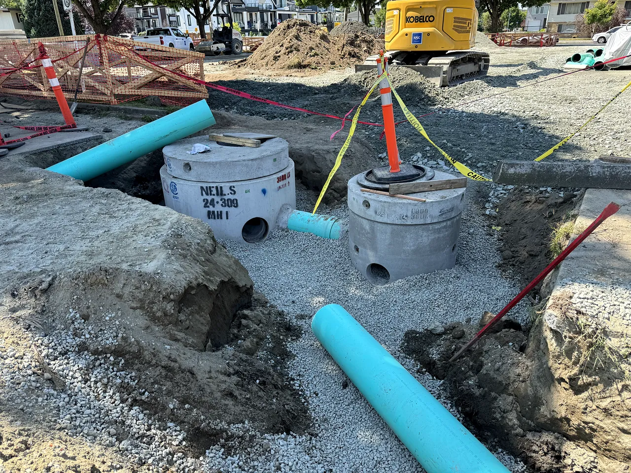 Precast manholes and PVC sewer pipe set in the trench