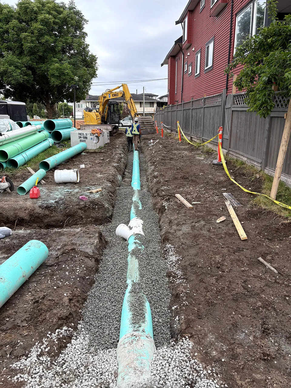New PVC sewer main laid in the trench along the lane